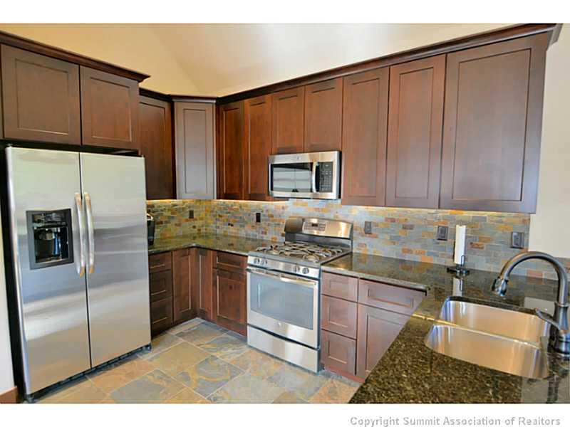 853 Independence Road, Unit 5B Keystone, CO 80435 - Photo 8 of 25 a kitchen with stainless steel appliances granite countertop a refrigerator sink and stove