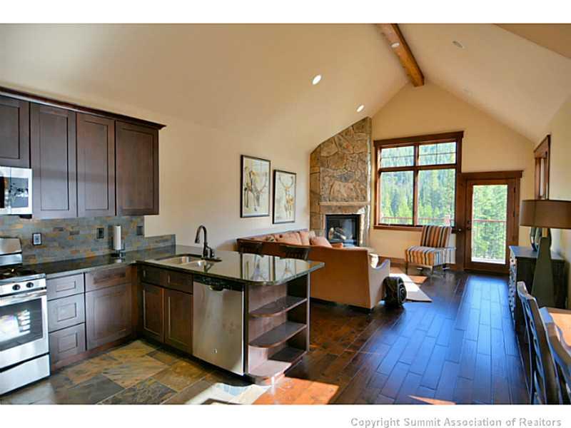 853 Independence Road, Unit 5B Keystone, CO 80435 - Photo 9 of 25 a kitchen with a sink and wooden cabinets