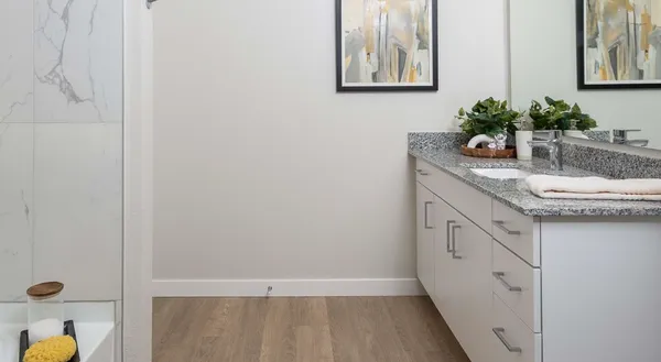 a bathroom with a granite countertop sink a mirror and vanity