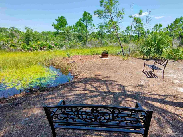 a spacious bedroom with a bed and a lamp
