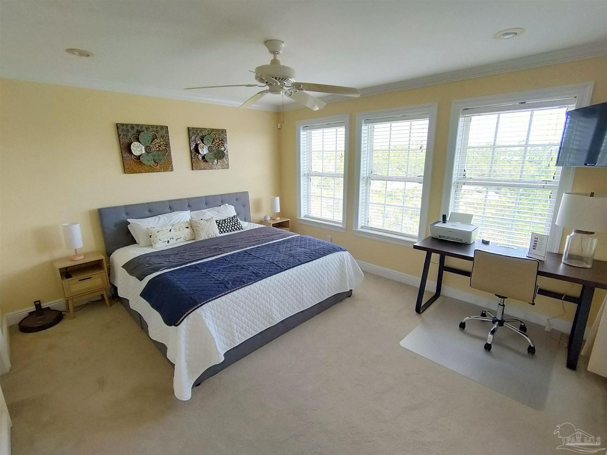 864 Sailfish Court Perdido Key, FL 32507 - Photo 24 of 40 a bedroom with a bed a table and a large window