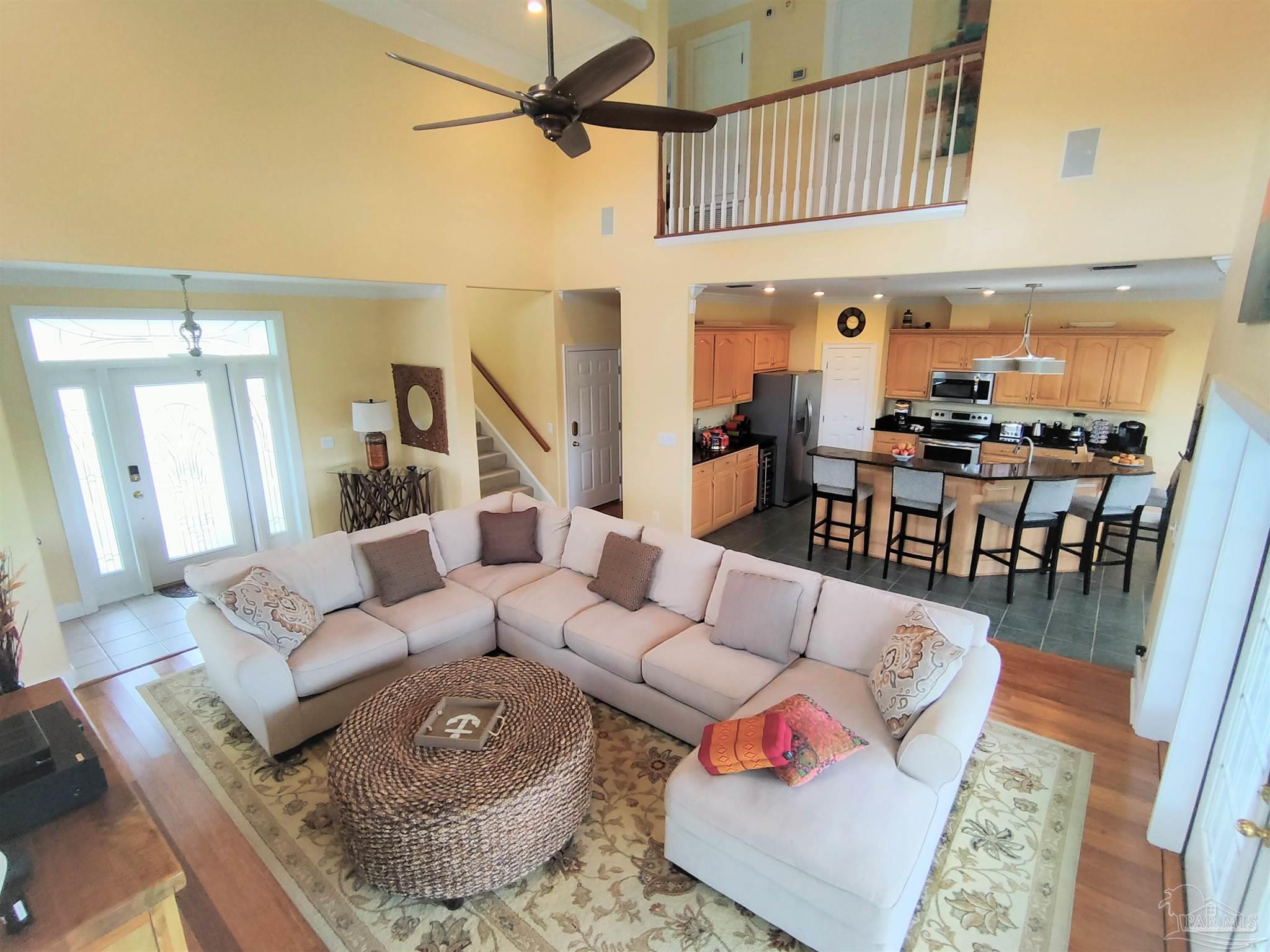 864 Sailfish Court Perdido Key, FL 32507 - Photo 5 of 40 a living room with furniture a rug and a chandelier