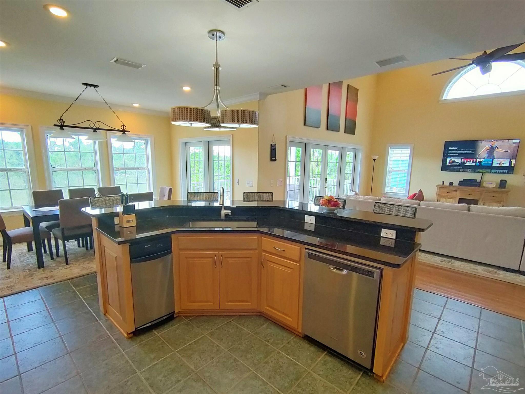 864 Sailfish Court Perdido Key, FL 32507 - Photo 7 of 40 a open kitchen with stainless steel appliances granite countertop a sink a stove and a dining table