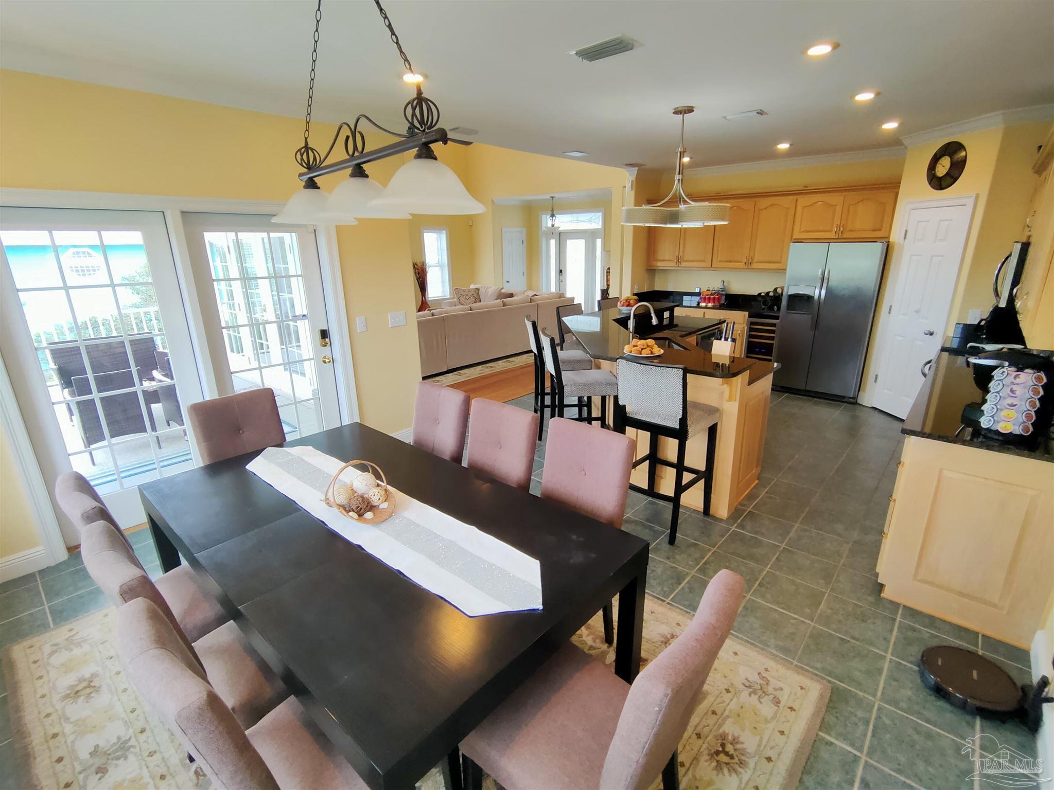 864 Sailfish Court Perdido Key, FL 32507 - Photo 8 of 40 a view of a dining room with furniture window and wooden floor
