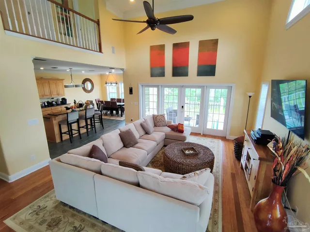 a living room with furniture fireplace and wooden floor