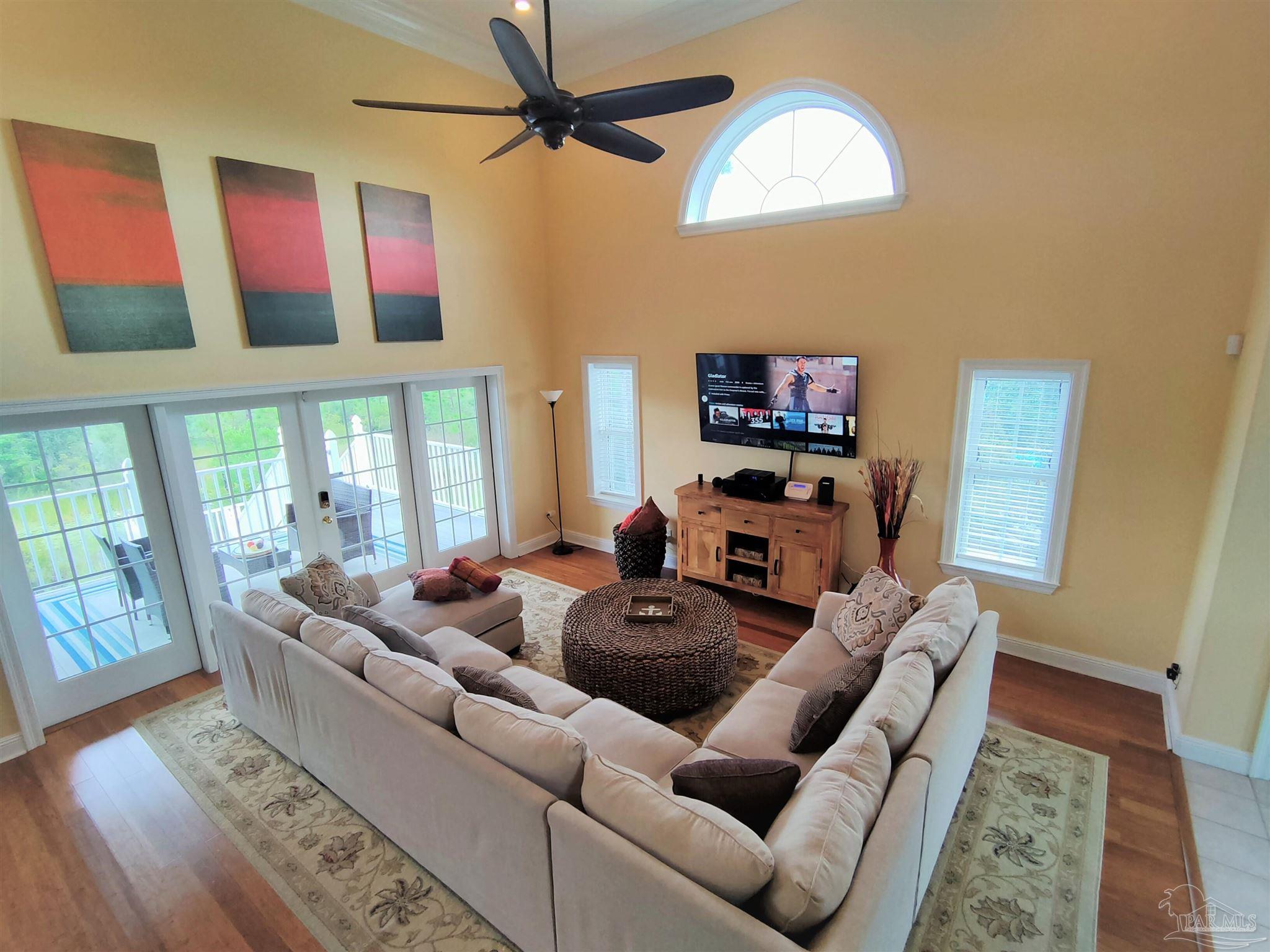 864 Sailfish Court Perdido Key, FL 32507 - Photo 10 of 40 a living room with furniture a flat screen tv and a large window