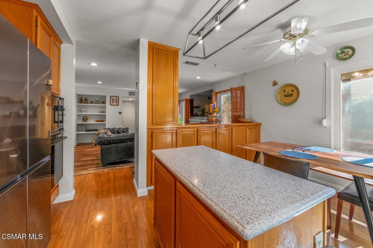3037 Klamath Avenue Simi Valley, CA 93063 - Photo 11 of 38 a kitchen with stainless steel appliances granite countertop a sink and a refrigerator