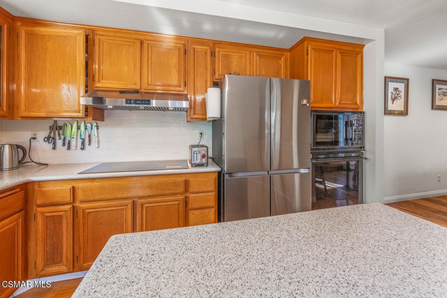 3037 Klamath Avenue Simi Valley, CA 93063 - Photo 13 of 38 a kitchen with stainless steel appliances granite countertop a refrigerator and a sink