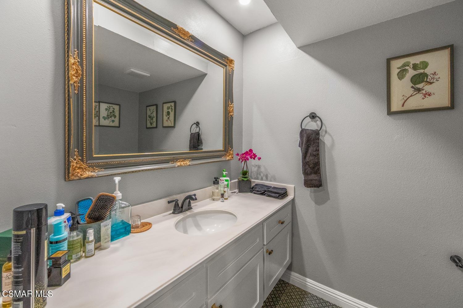 3037 Klamath Avenue Simi Valley, CA 93063 - Photo 15 of 38 a bathroom with a sink and a mirror