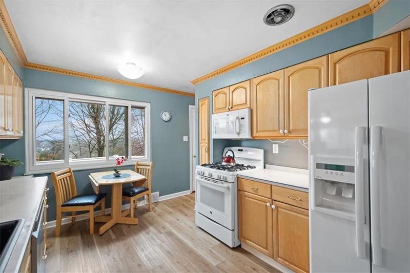 209 Cherokee Road Pittsburgh, PA 15241 - Photo 14 of 41 a kitchen with a table chairs refrigerator and cabinets