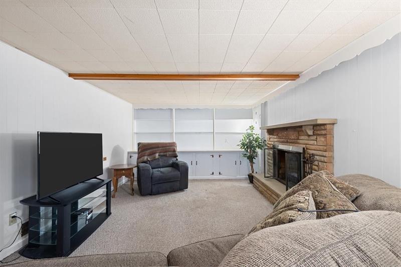 209 Cherokee Road Pittsburgh, PA 15241 - Photo 29 of 41 a living room with furniture and a flat screen tv