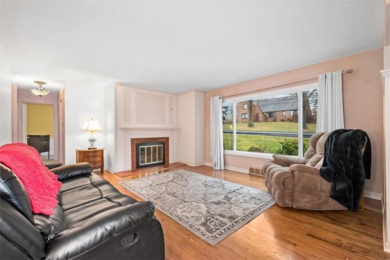 209 Cherokee Road Pittsburgh, PA 15241 - Photo 4 of 41 a living room with furniture and a fireplace