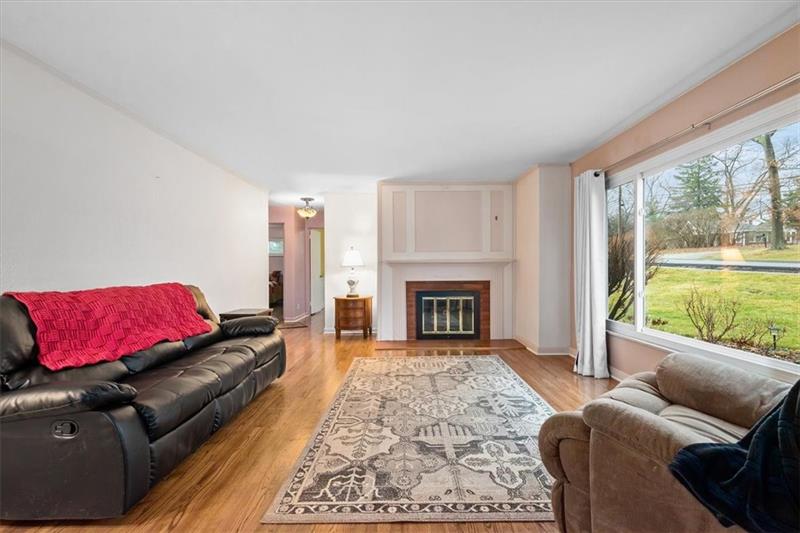 209 Cherokee Road Pittsburgh, PA 15241 - Photo 5 of 41 a living room with furniture and a fireplace