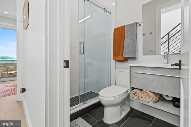 a bathroom with a toilet and a shower