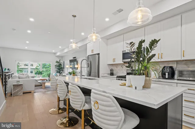 a kitchen with stainless steel appliances granite countertop a stove and a sink