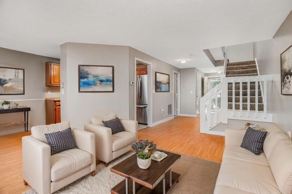 516 Ridgefield Circle, Unit C Clinton, MA 01510 - Photo 12 of 36 a living room with furniture a rug and a window