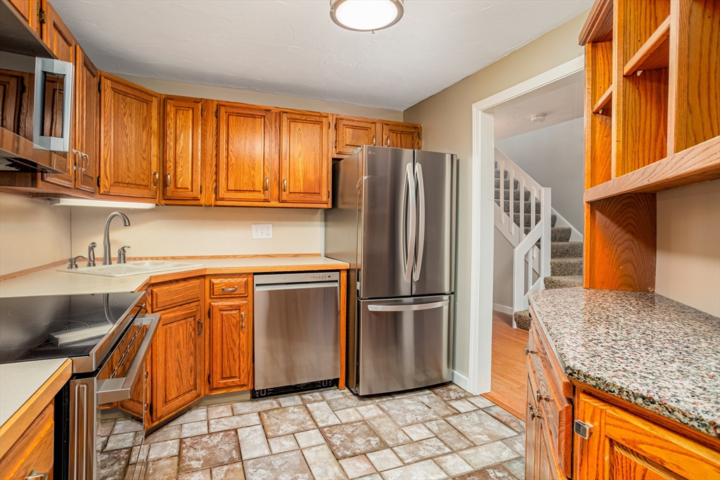 516 Ridgefield Circle, Unit C Clinton, MA 01510 - Photo 3 of 36 a kitchen with stainless steel appliances granite countertop a refrigerator and a sink