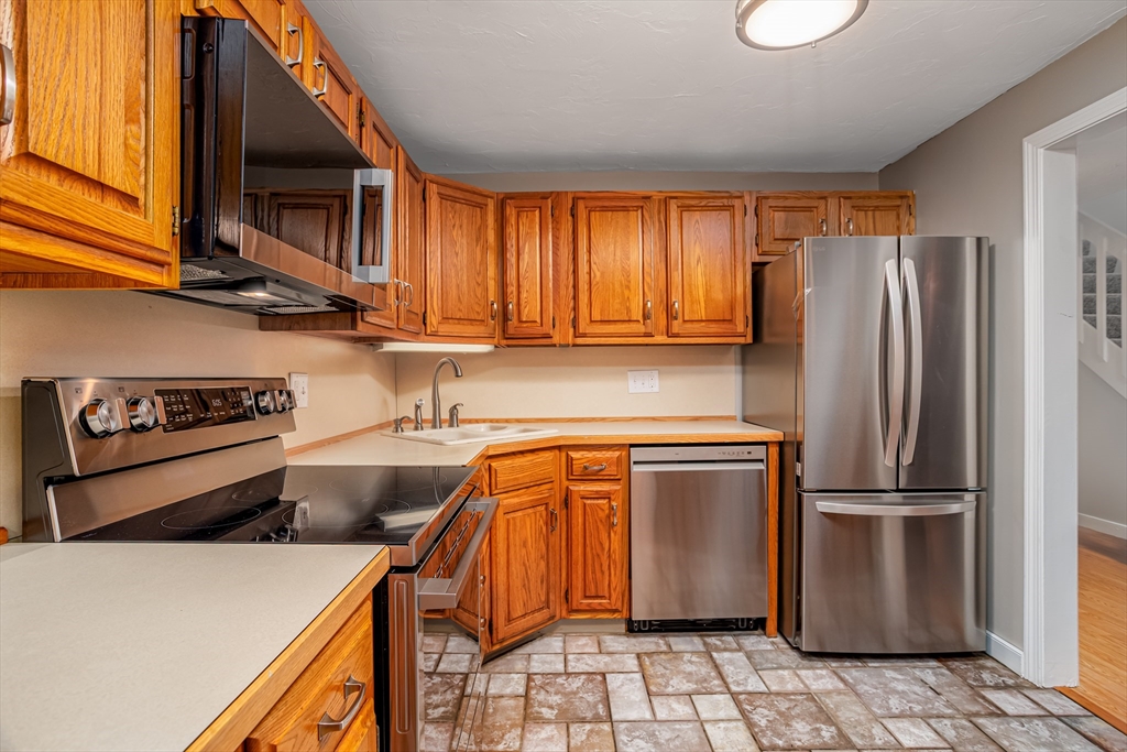 516 Ridgefield Circle, Unit C Clinton, MA 01510 - Photo 4 of 36 a kitchen with stainless steel appliances granite countertop a refrigerator a sink and a stove