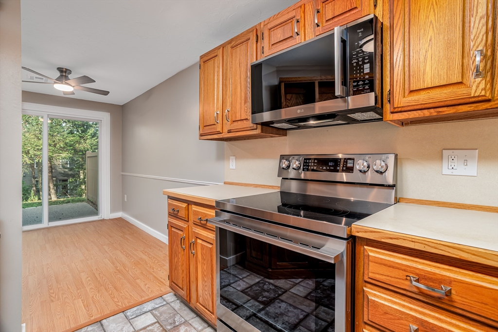516 Ridgefield Circle, Unit C Clinton, MA 01510 - Photo 5 of 36 a kitchen with stainless steel appliances granite countertop a stove microwave and sink