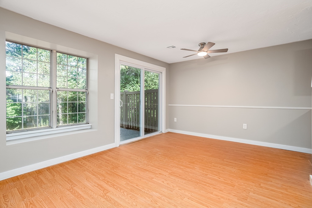 516 Ridgefield Circle, Unit C Clinton, MA 01510 - Photo 6 of 36 a view of an empty room with a window and wooden floor
