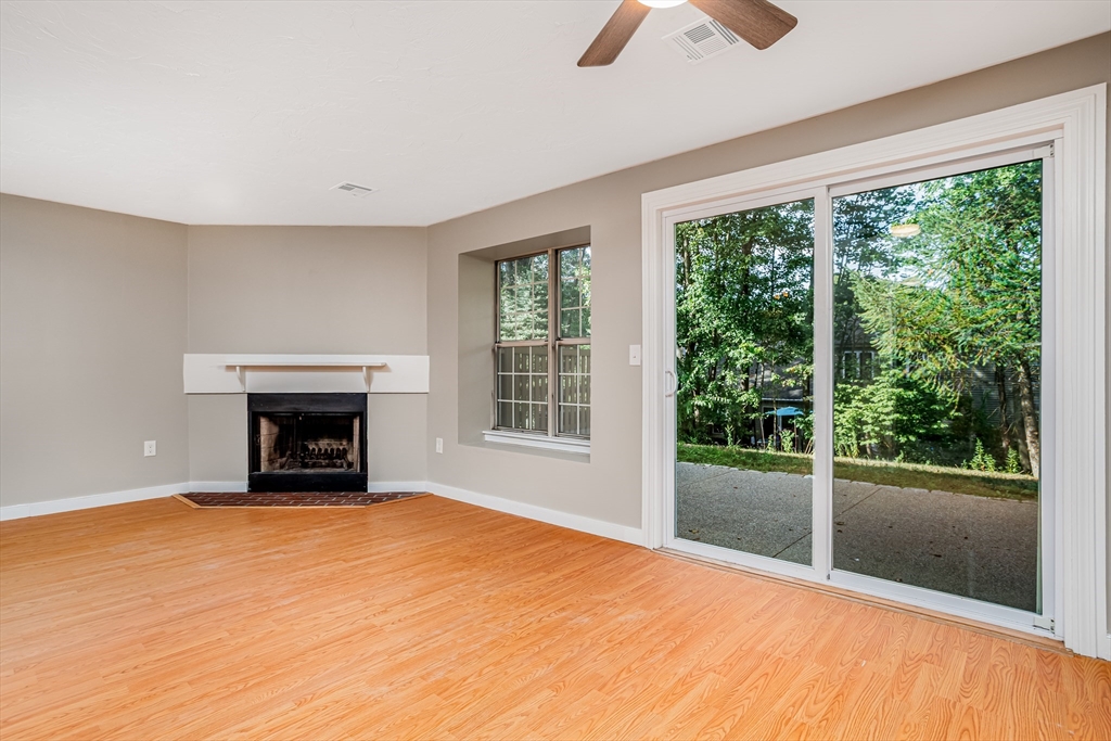 516 Ridgefield Circle, Unit C Clinton, MA 01510 - Photo 7 of 36 a view of an empty room with window and fire place