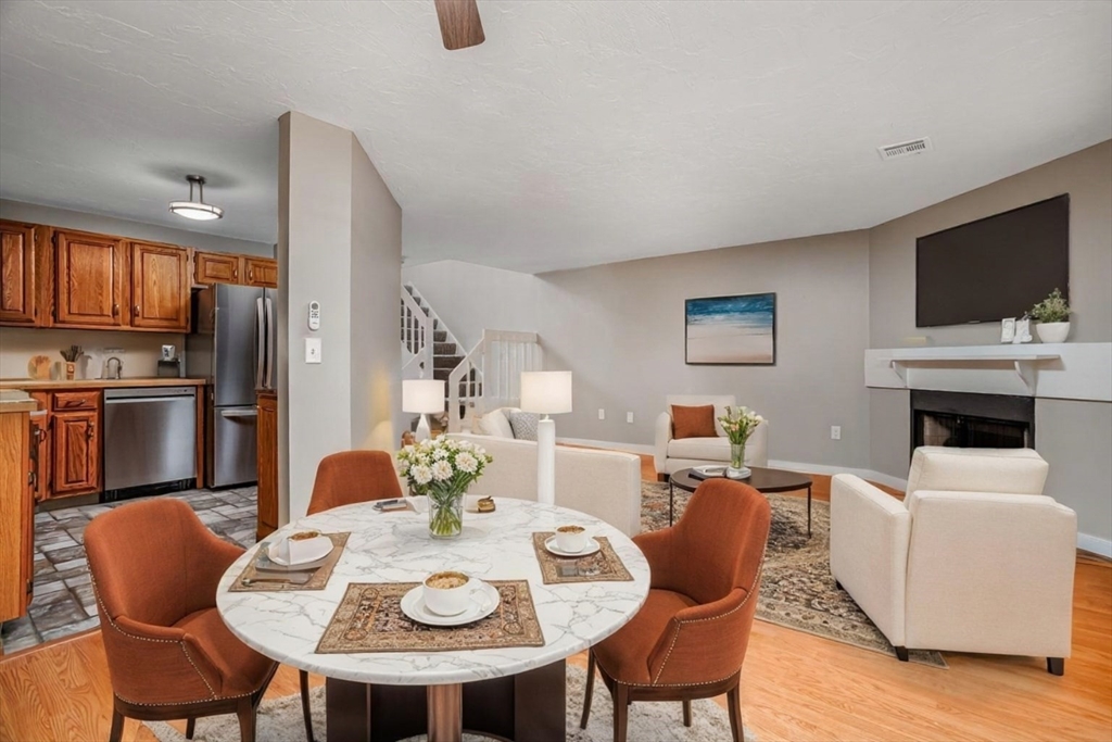516 Ridgefield Circle, Unit C Clinton, MA 01510 - Photo 10 of 36 a view of a dining room with furniture a fireplace and wooden floor