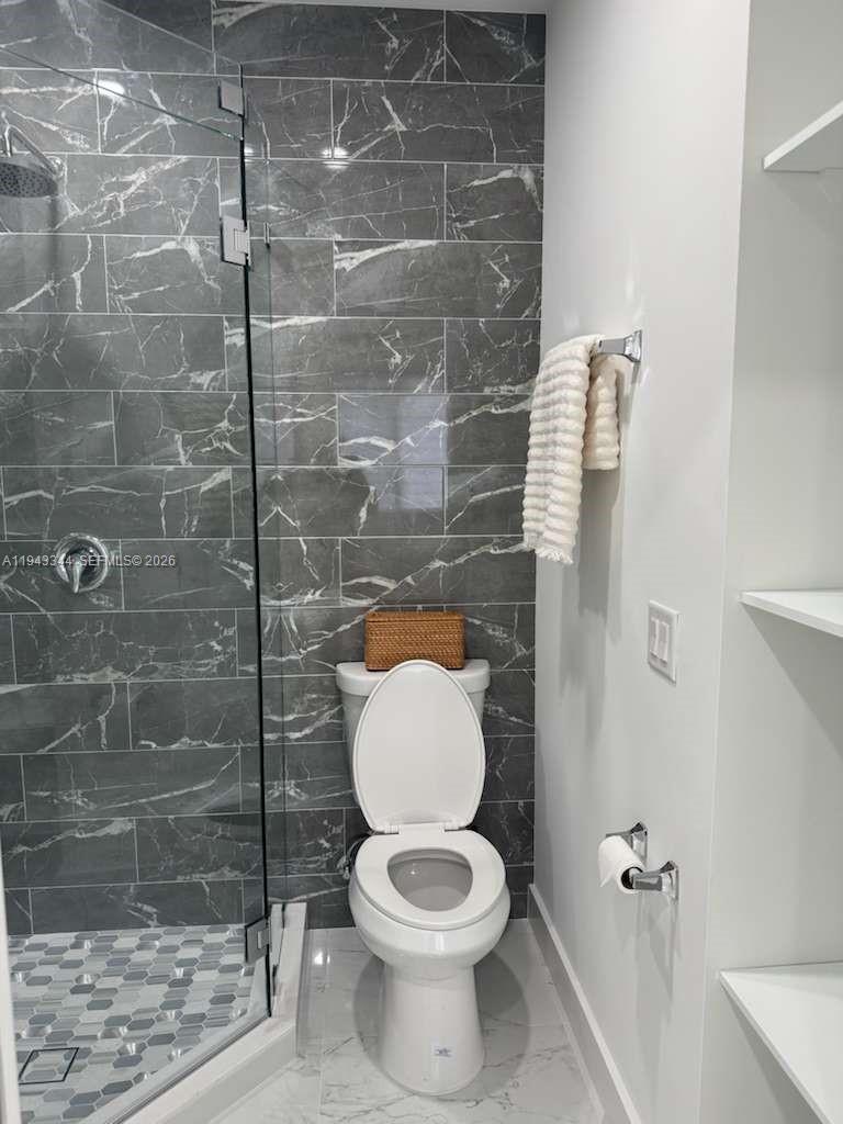 12970 Southwest 187th Street, Unit EFFICIENCY Miami, FL 33177 - Photo 13 of 30 a bathroom with a toilet and a shower
