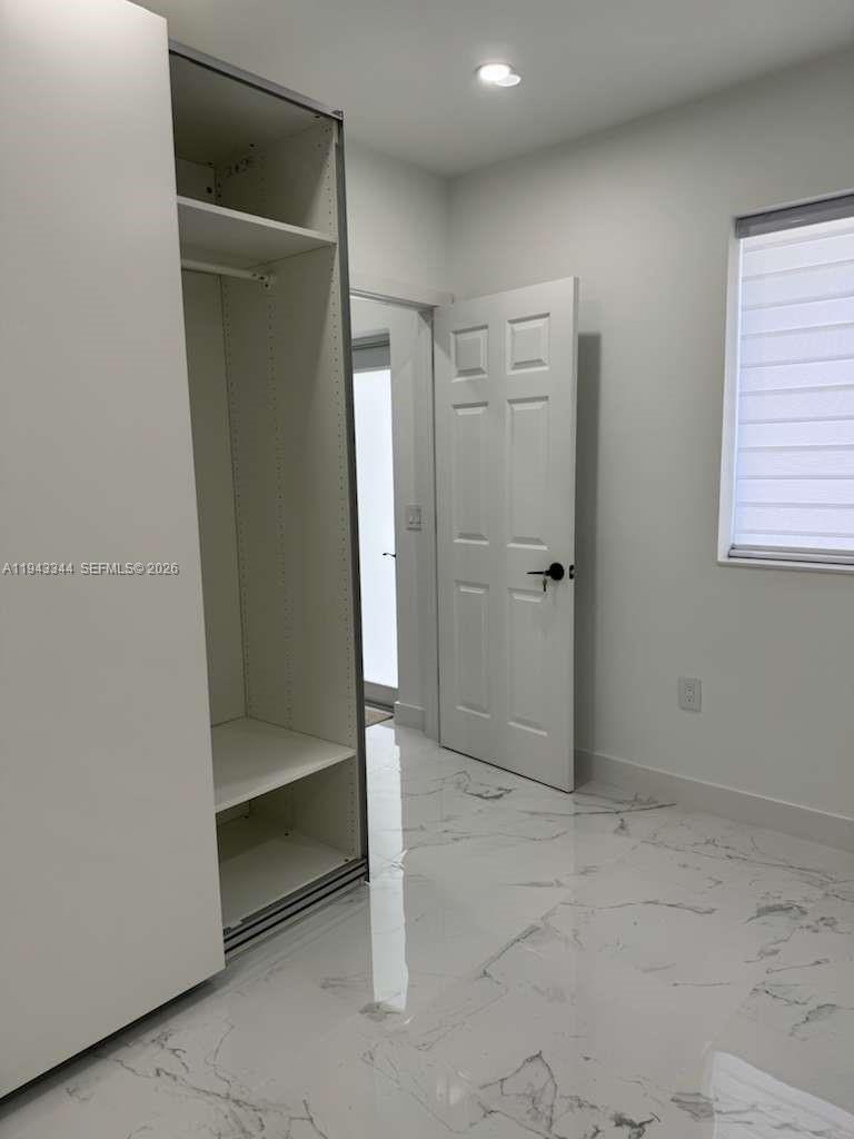 12970 Southwest 187th Street, Unit EFFICIENCY Miami, FL 33177 - Photo 14 of 30 an empty room with closet