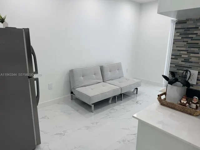 a living room with furniture a air conditioner and a window