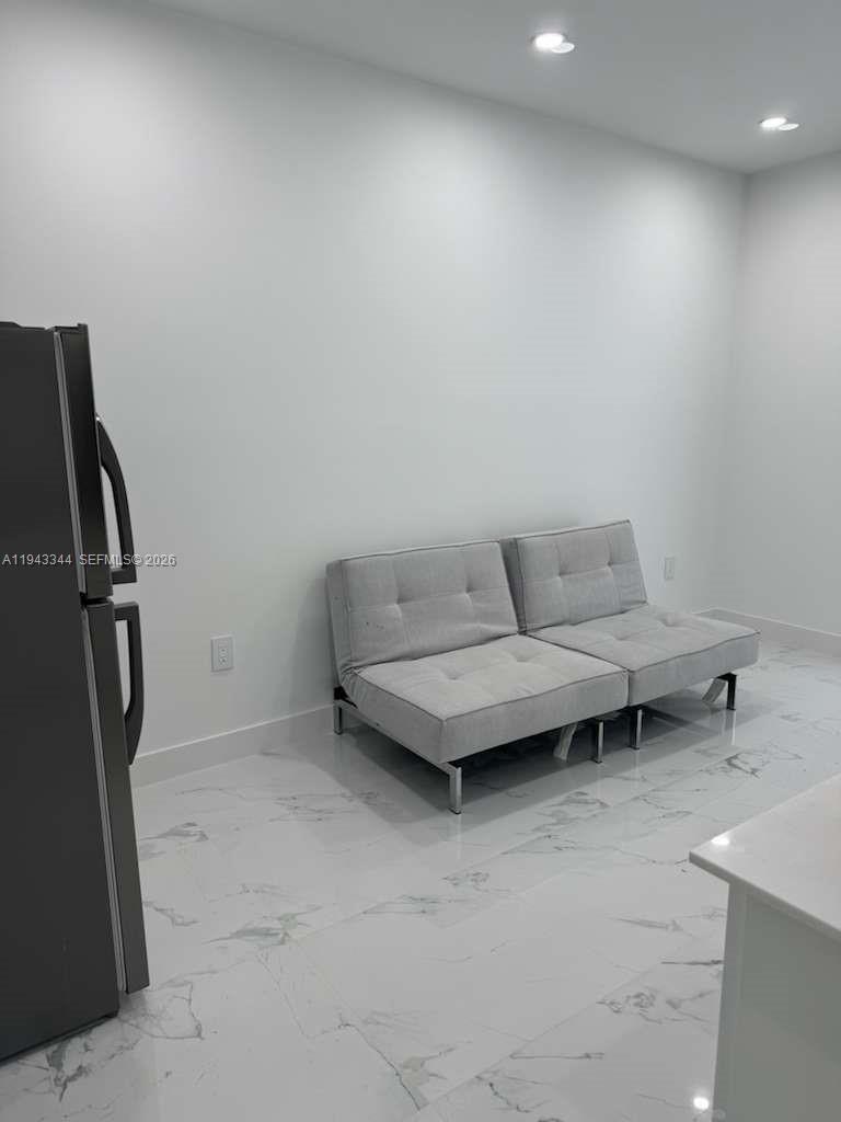 12970 Southwest 187th Street, Unit EFFICIENCY Miami, FL 33177 - Photo 24 of 30 a living room with furniture a air conditioner vent and a rug