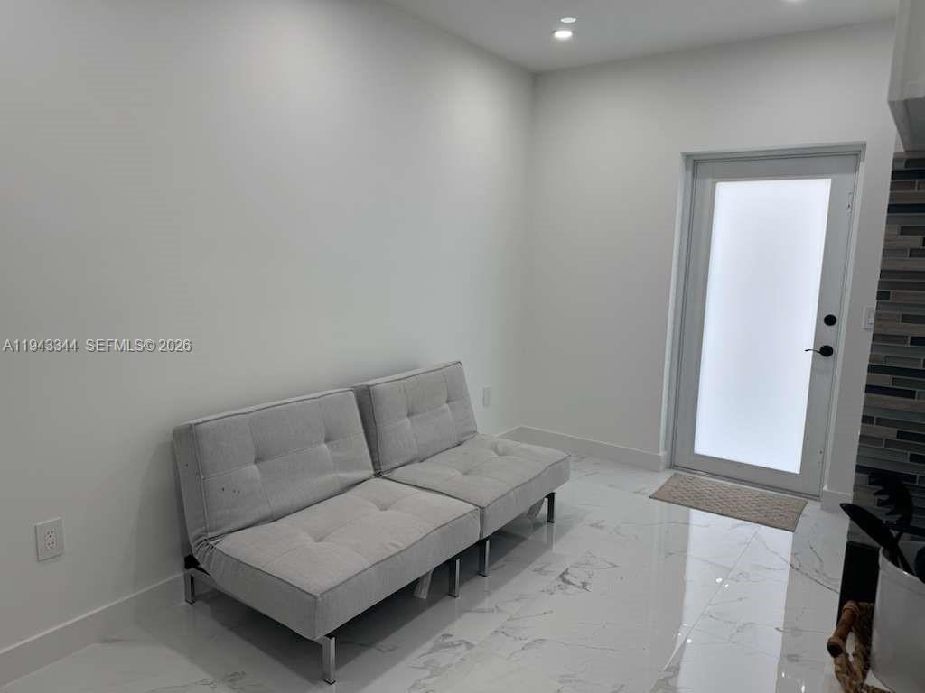 12970 Southwest 187th Street, Unit EFFICIENCY Miami, FL 33177 - Photo 4 of 30 a living room with furniture and a flat screen tv