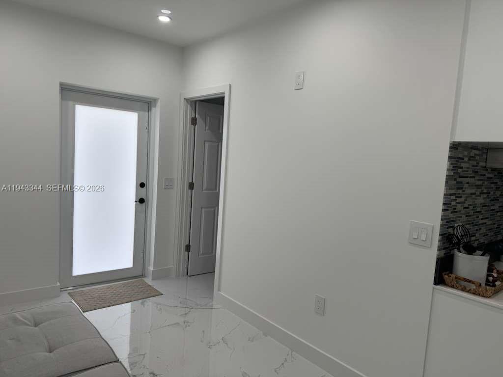 12970 Southwest 187th Street, Unit EFFICIENCY Miami, FL 33177 - Photo 5 of 30 a view of room with window and front door