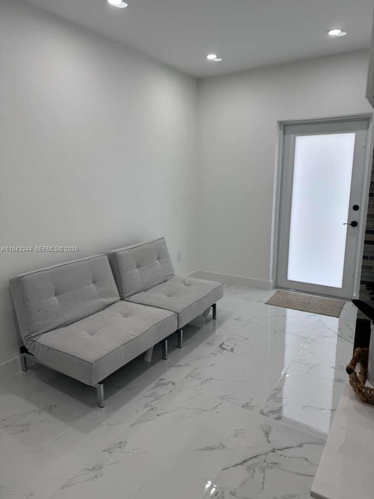 12970 Southwest 187th Street, Unit EFFICIENCY Miami, FL 33177 - Photo 7 of 30 a living room with furniture and a mirror