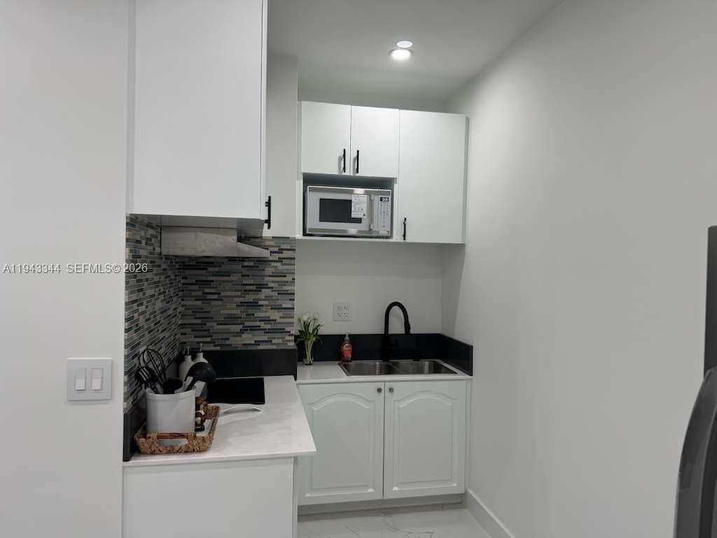 12970 Southwest 187th Street, Unit EFFICIENCY Miami, FL 33177 - Photo 10 of 30 a kitchen with a sink and cabinets