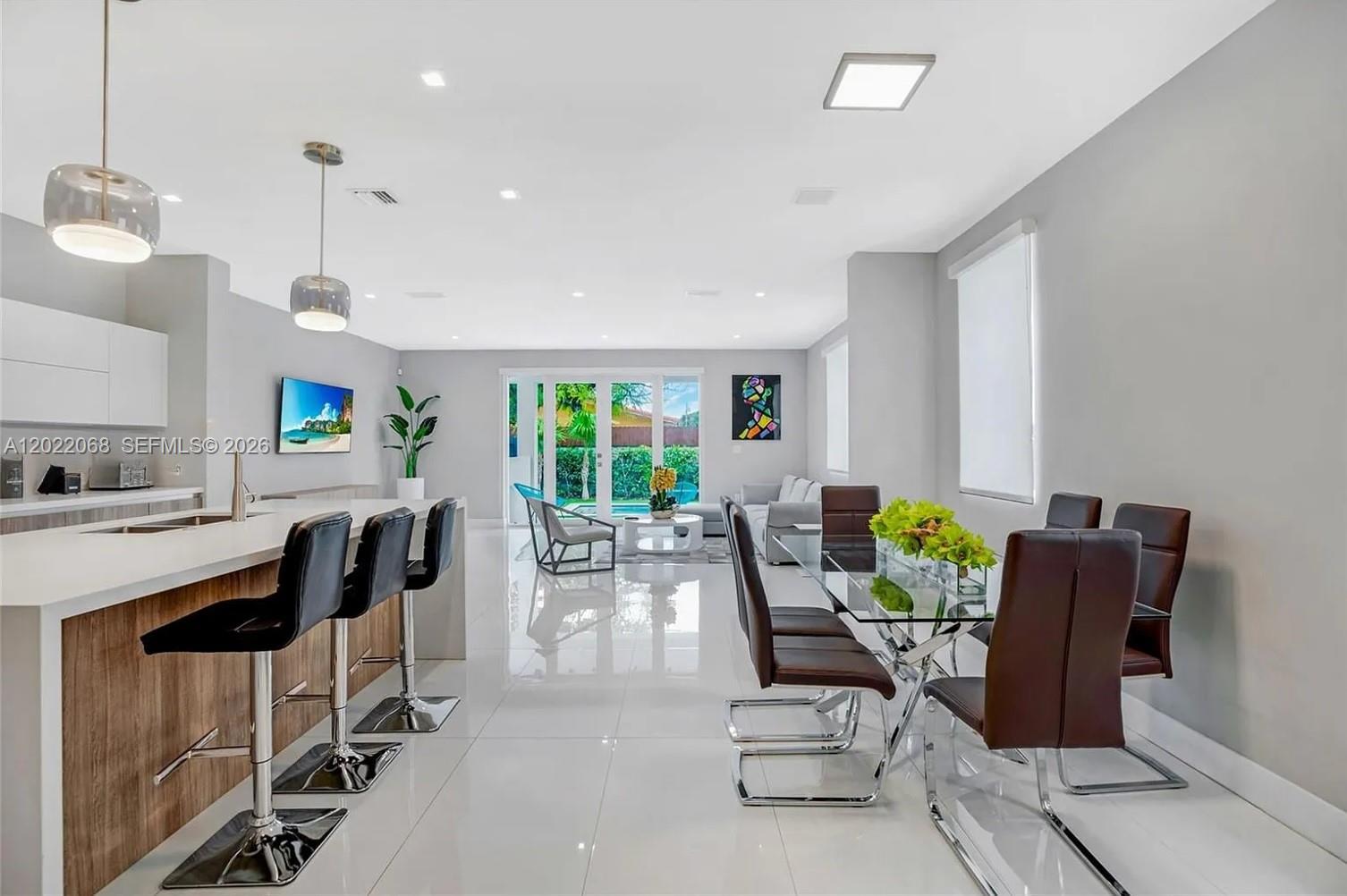 3657 Southwest 26th Street Miami, FL 33133 - Photo 3 of 12 a dining room with furniture and a floor to ceiling window