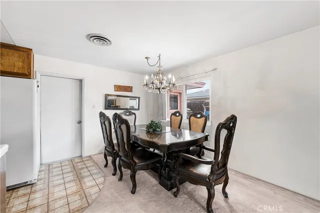 a view of a dining room with furniture and window