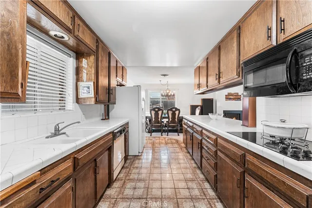 a kitchen with stainless steel appliances granite countertop a sink and a stove