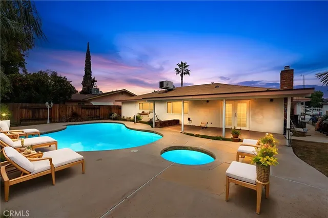 a swimming pool with outdoor seating