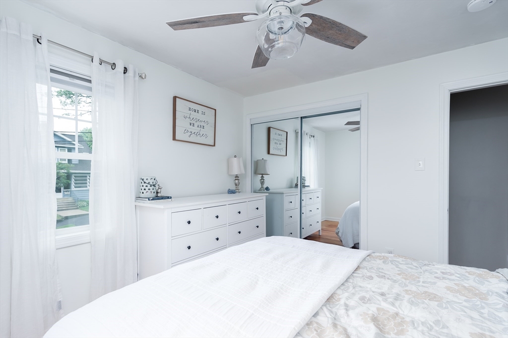 162 King Philip Road Worcester, MA 01606 - Photo 20 of 26 a bedroom with a bed and a chandelier