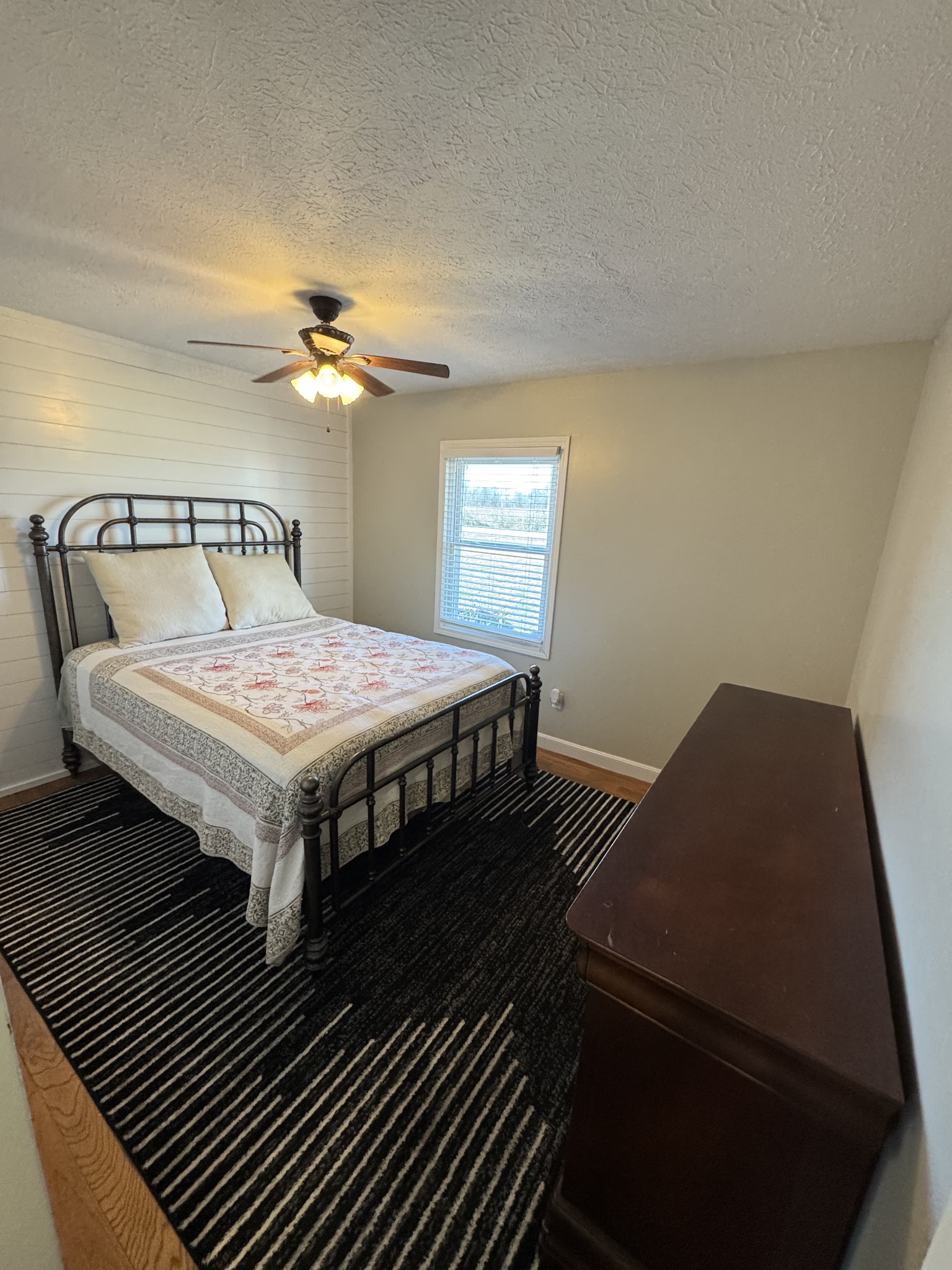 800 Pea Ridge-Sharon Grove Road Elkton, KY 42220 - Photo 21 of 43 a bedroom with a bed and a chandelier