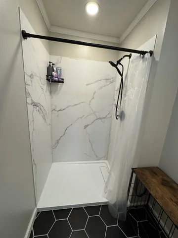 a bathroom with a bathtub and shower