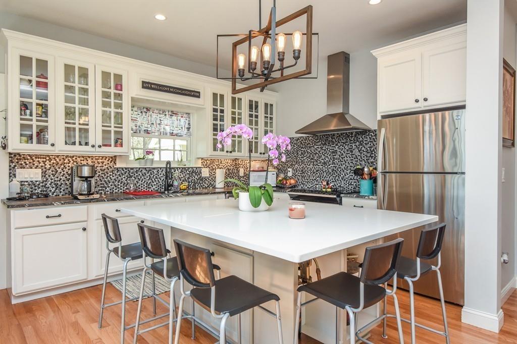 6 Edgehill Road Billerica, MA 01862 - Photo 15 of 24 a kitchen with a dining table and chairs