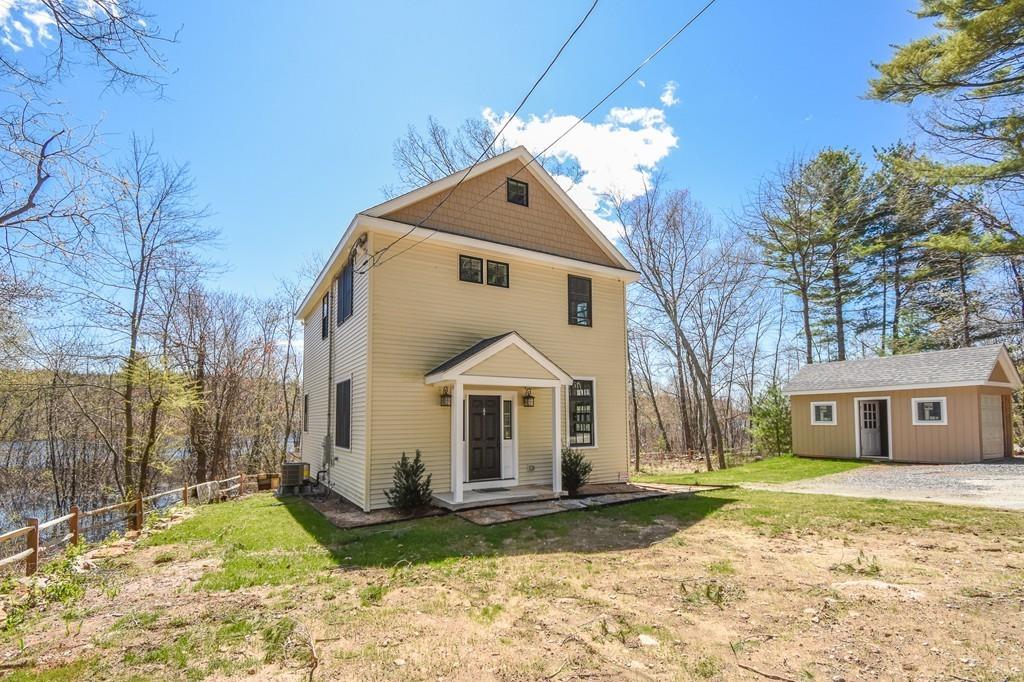 6 Edgehill Road Billerica, MA 01862 - Photo 2 of 24 a front view of a house with a yard and garage