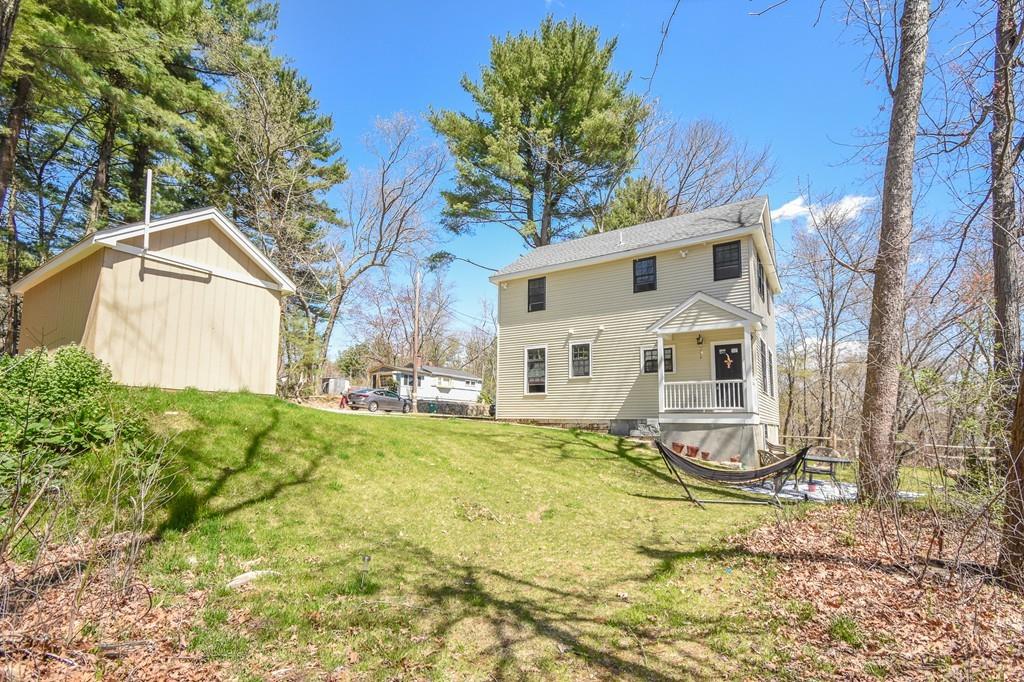 6 Edgehill Road Billerica, MA 01862 - Photo 8 of 24 a white house that has a tree in front of it