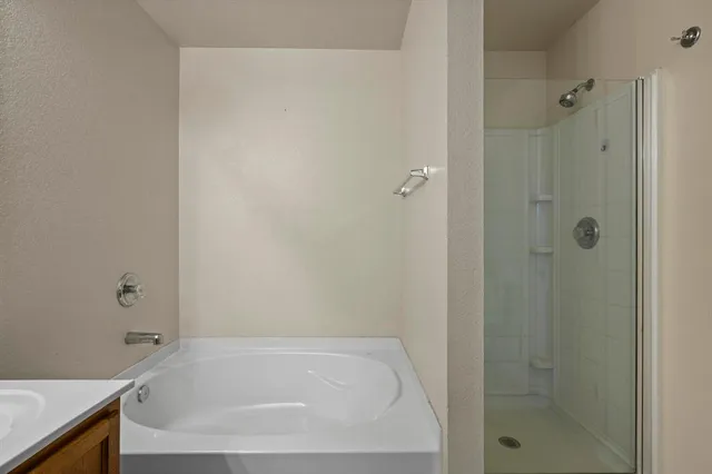 a bathroom with a tub and shower