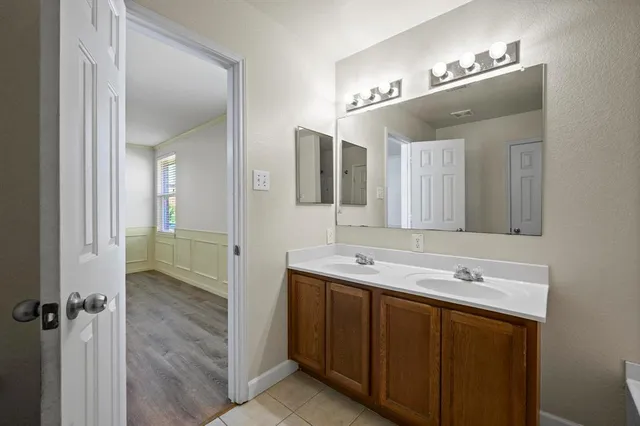 a bathroom with a double vanity sink and mirror