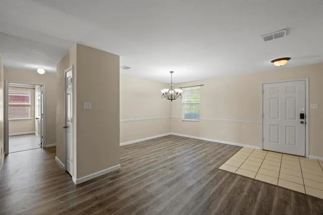 an empty room with wooden floor