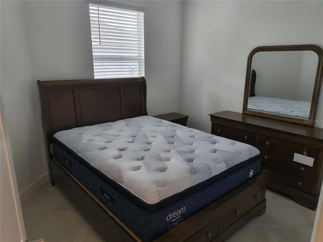 a bedroom with a bed and window