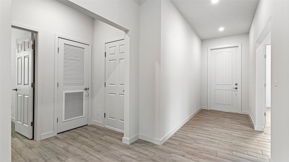 7008 Eden Road Fort Pierce, FL 34951 - Photo 25 of 29 a view of a hallway with wooden floor