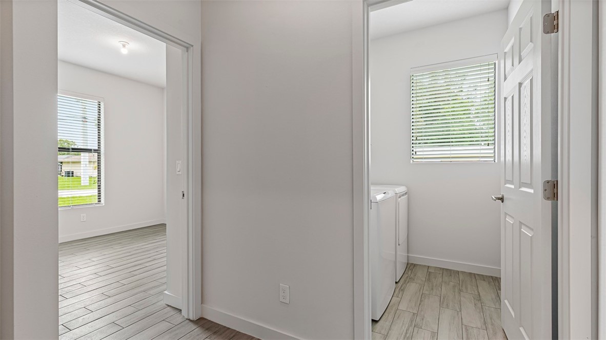 7008 Eden Road Fort Pierce, FL 34951 - Photo 27 of 29 a view of hallway with window and wooden floor